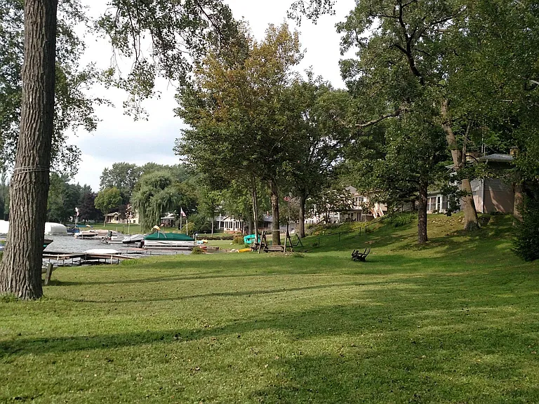 Lakeside view of yard and neighborhood