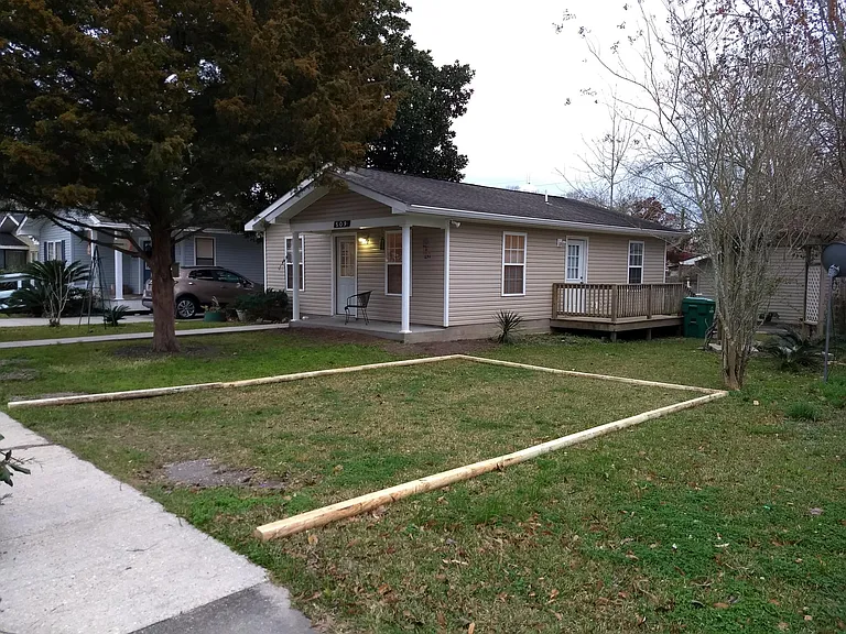 Side of house, parking, deck.