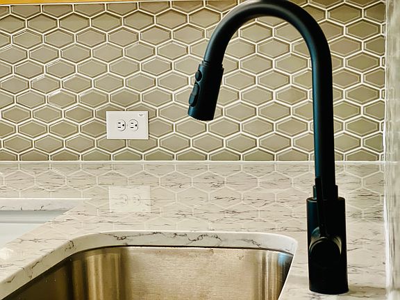 Beautiful Backsplash and luxury fixtures