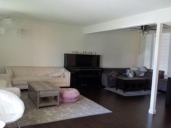 Family, Living, Dining room. Looking left from front entrance. Stairs are on the right. Half bath, coat closet is along the hall
