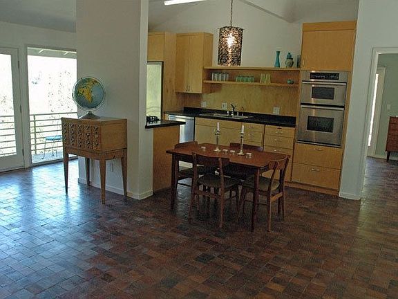 Loft-like living/dining room with high ceilings, fireplace and great views.