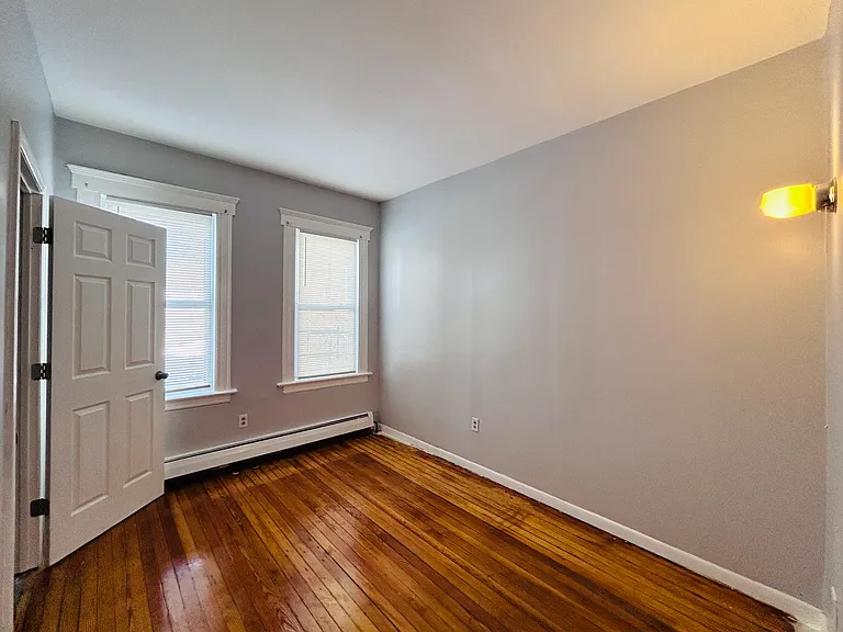 Bedroom 3 (back) with wall sconce light and outlet for wall mountable TV