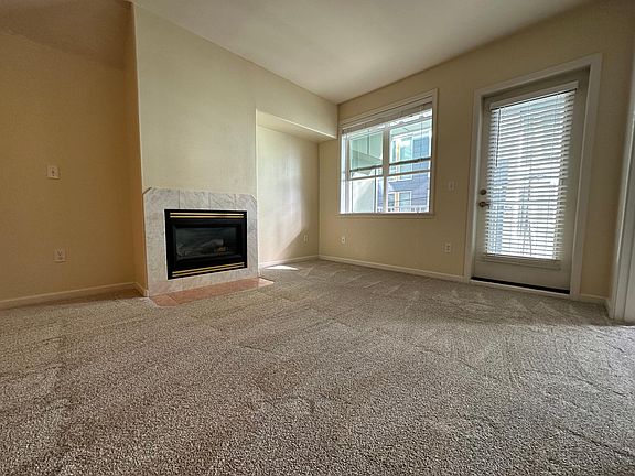 Living room with fireplace and door to balcony
