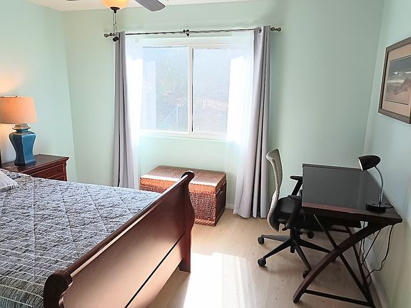 Workstation in room with desk and office share.