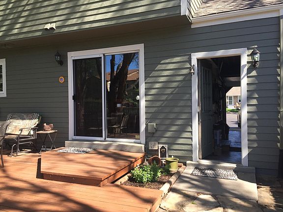 Back of home view with sliding glass door and garage access