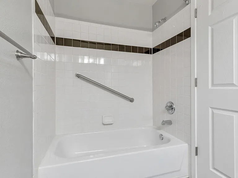 A Bathroom Tub/Shower at The Buttes Apartment Homes in Loveland, CO