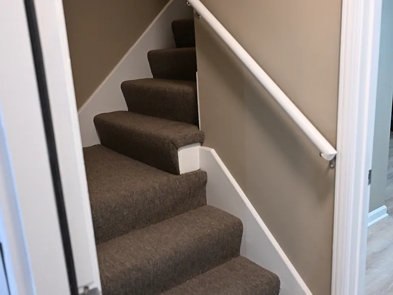 Stairs to main level from garage/basement. New carpet.