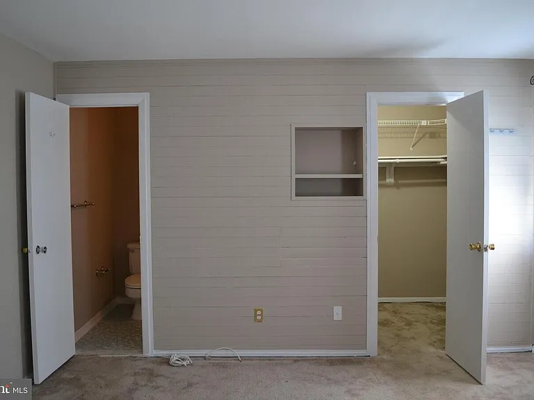 Master bedroom with walk in closet and attached full bath