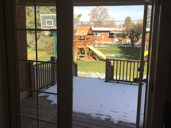 Looking from the kitchen to the large back yard with basketb