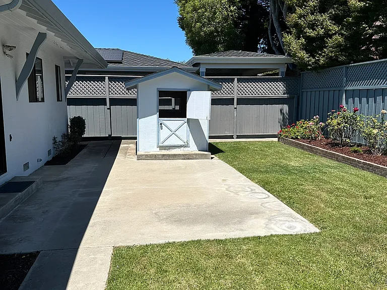 The rear yard includes a custom playhouse/gardening/storage unit. (watertight and built to last )