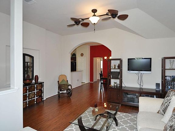 This family room is warm and inviting. Just look at the upgraded lighting fixtures and archways.