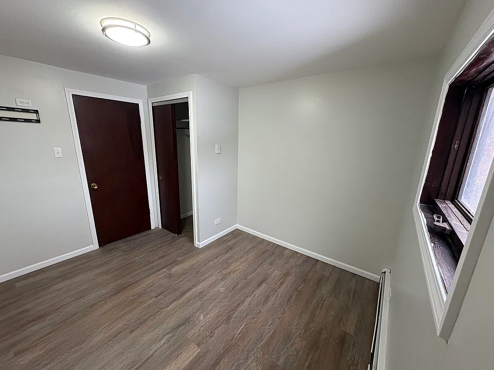 Primary bedroom - new flooring, lighting.