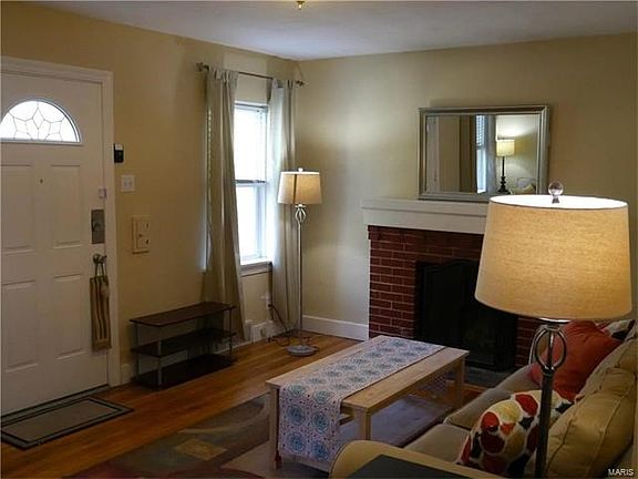 Charming bedroom with functional wood-burning fireplace.