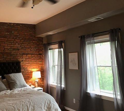master bedroom with electric blinds