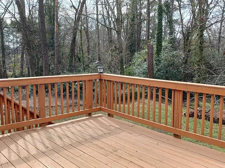Spacious deck with stairs to backyard.