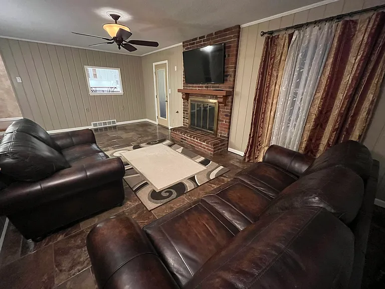 Matching Leather Lazy-Boy Sofa and Loveseat. nice carpet over beautiful shiny tile. Very nice, natural gas assisted fireplace with Like New 55" Samsung TV. Remote control fan/light.
