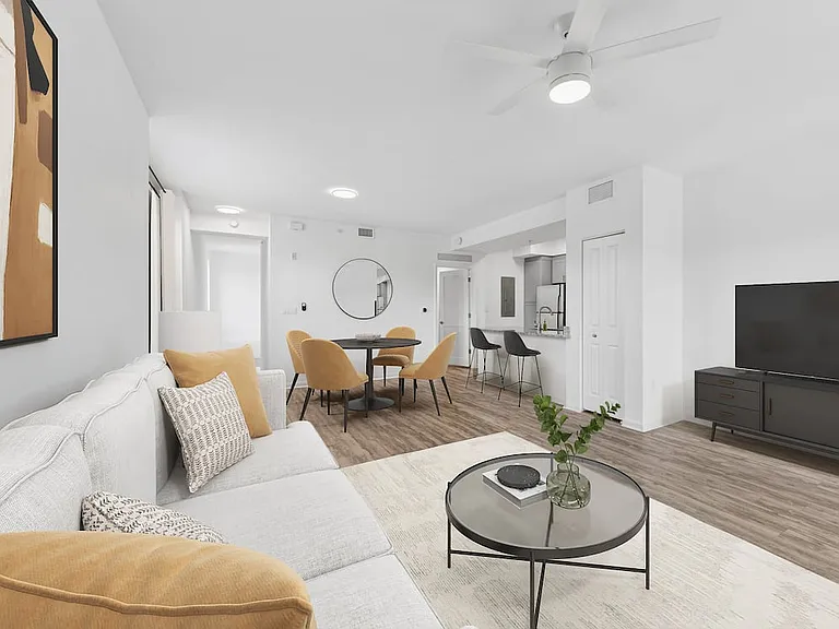 Renovated Package I dining and living room with hard-surface vinyl plank flooring