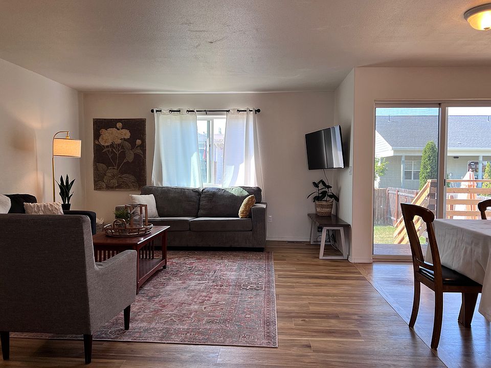 living room. Bedrooms and hallway to the left. Kitchen/dining room to the right. Backyard through the sliding glass door.