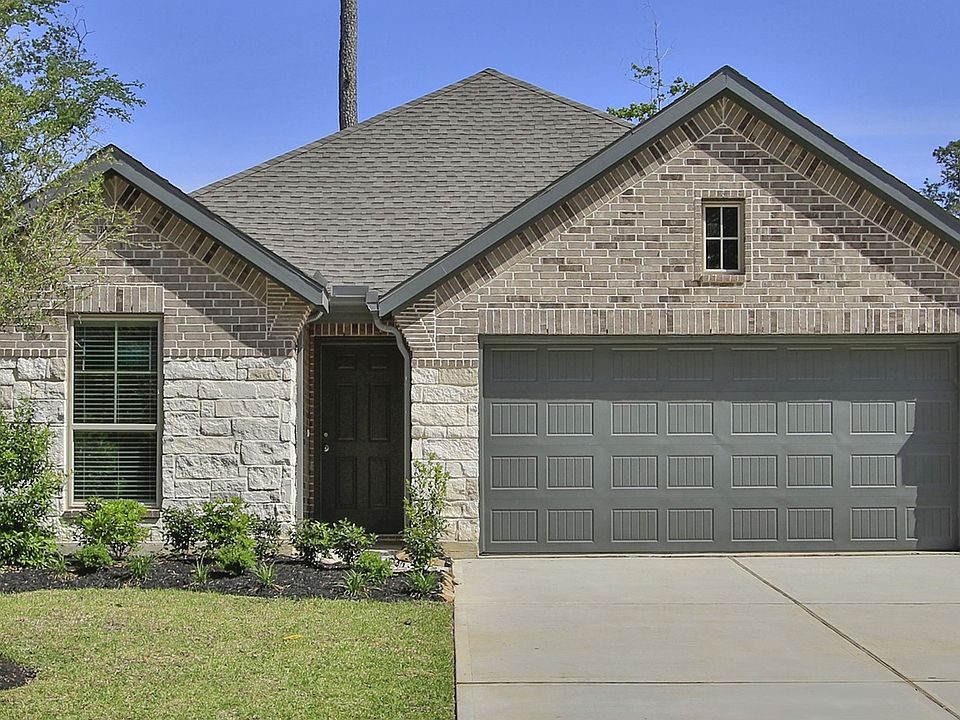Elegant gable roof and stone facade define this residence in The Woodlands Hills, exuding refined ap