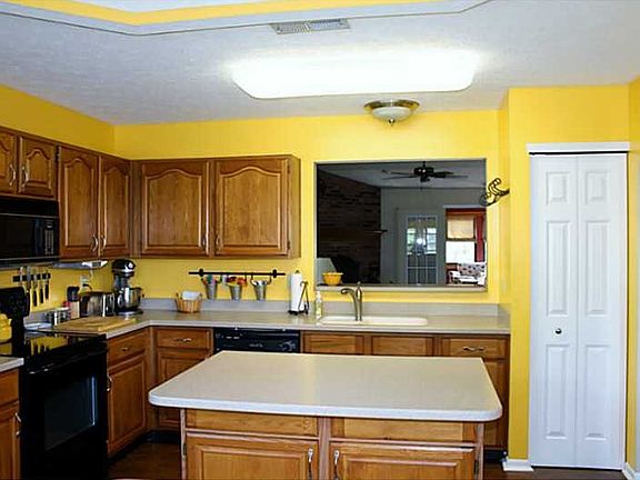 Kitchen. Kitchen with oak raised panel cabinets & center island-all with Corian counter