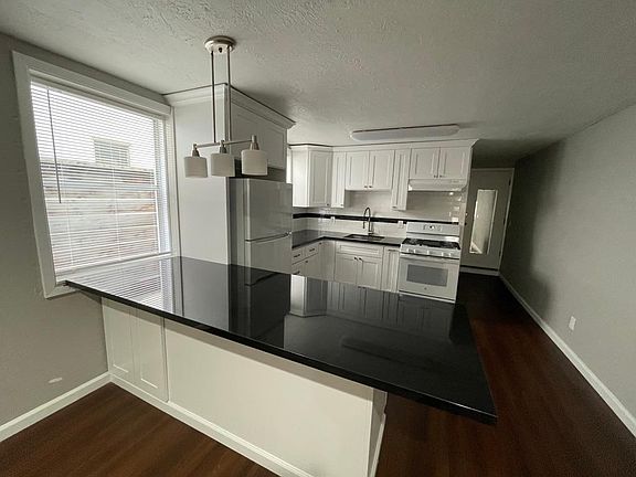 Kitchen with 3' x 8' granite peninsula with ample storage underneath.