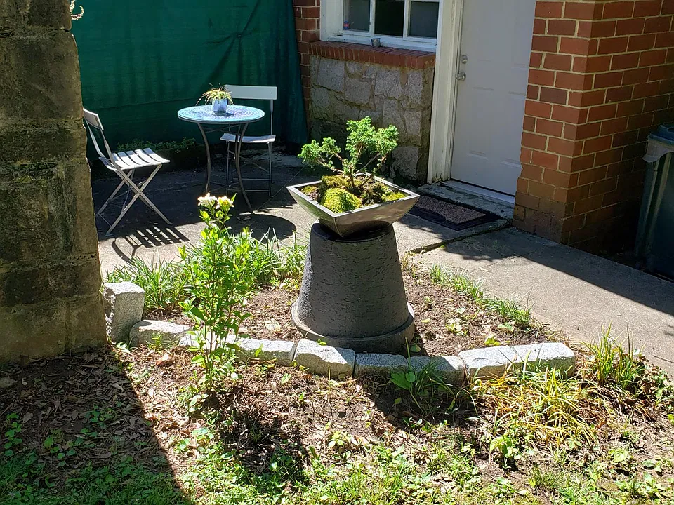 Front door and secluded patio looking to pollinator habitat on corner lot