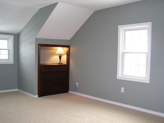 Large sunny bedroom with built-ins