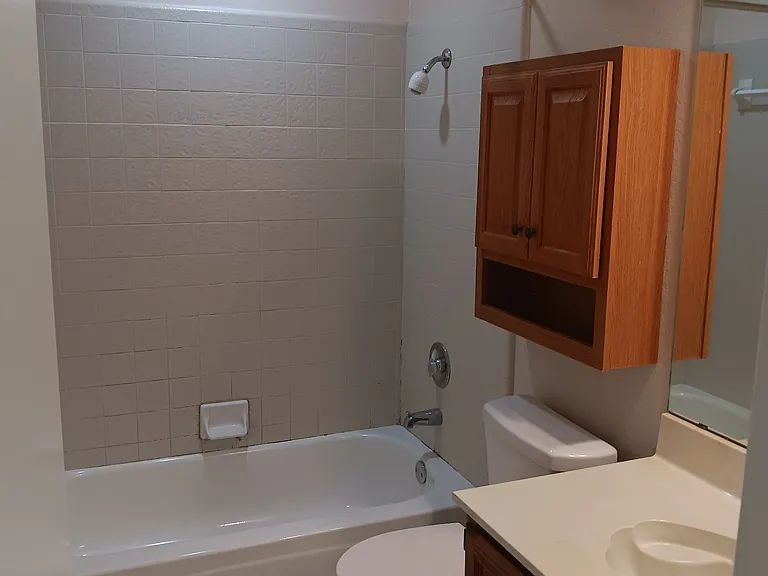 Enjoy quick shower or soaking bath with this full suite bathroom! Tile floor, easy to sit, chair height and water efficient toilet. original wood cabinets. Can be guests or yourself.