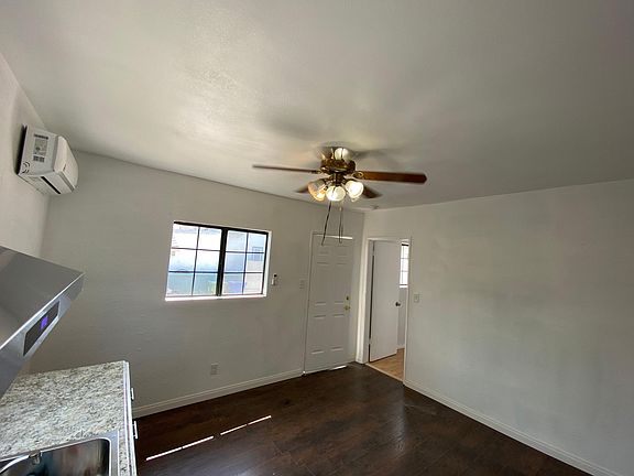 Kitchen view towards front door and bedroom