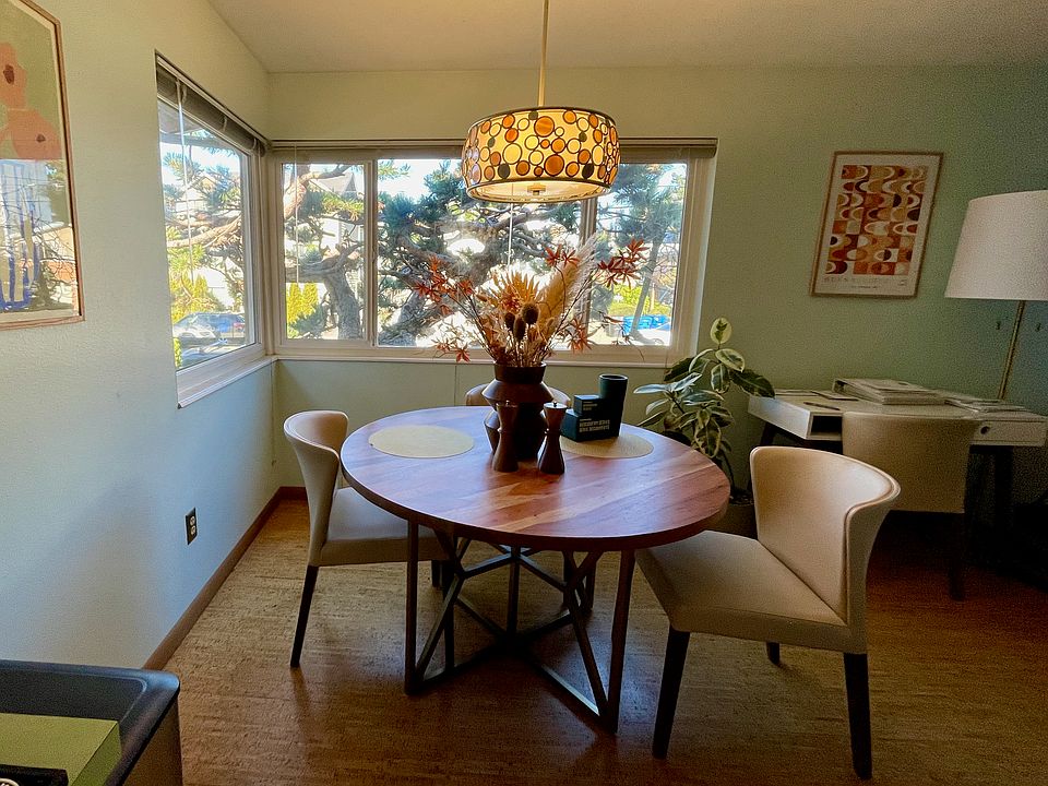 Dining area with corner windows, view to shore pine. Cork floors.