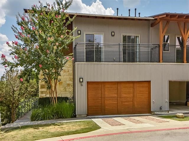 Coveted corner unit with 2 car garage and covered porches on front and back of this amazing condo!