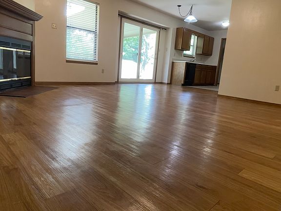 View from Hallway looking into LVRM, Kitchen, and Large Door that overlooks the Spacious Backyard.