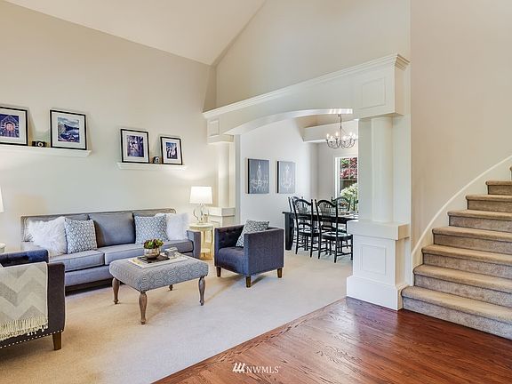 Dramatic vaulted two story entry, handsome refinished hardwood floors and curved staircase greet you