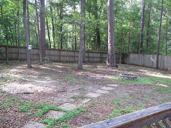 fenced in back yard with firepit