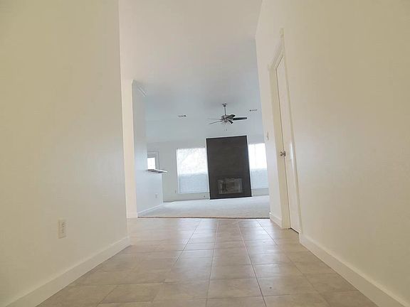 Vuew from entry to Living Room. Fireplace, large windows.