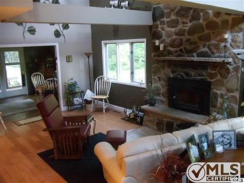 Real Hardwood Floors, Floor to Ceiling Field Stone Fireplace, and tons of windows to look out. This is an awesome place to enjoy Family Times.