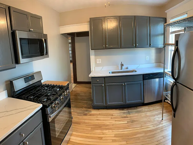 New quartz countertop, sink, stainless steel gas range and microwave!