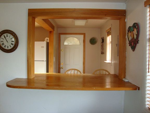 Neat kitchen pass thru with large built in table! Room for four people to have a meal!