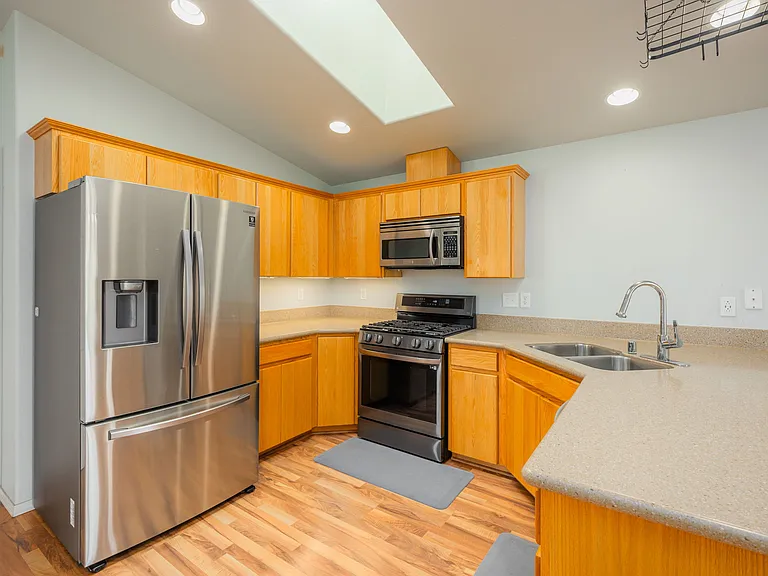 Kitchen w/gas range, microwave and refrigerator.