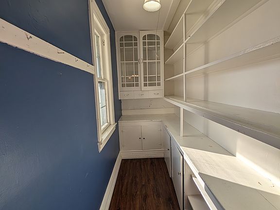 Large walk-in pantry with plenty of shelving for extra food, instant pots and other appliances