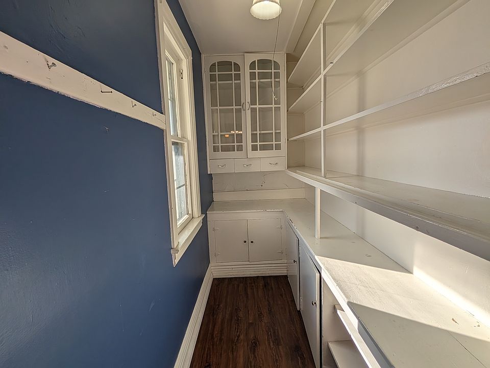 Large walk-in pantry with plenty of shelving for extra food, instant pots and other appliances