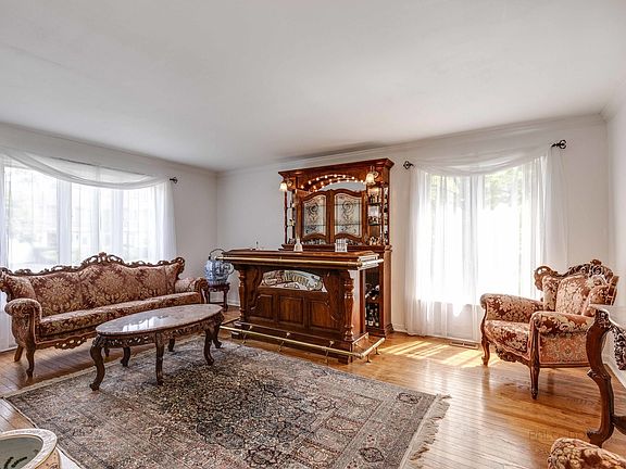 Loads of windows and oak floors for an elegant formal living room.