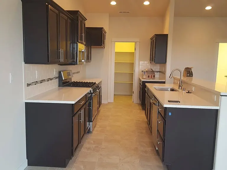 Kitchen with walk-in pantry; comes with stainless steel fridge (not shown here)