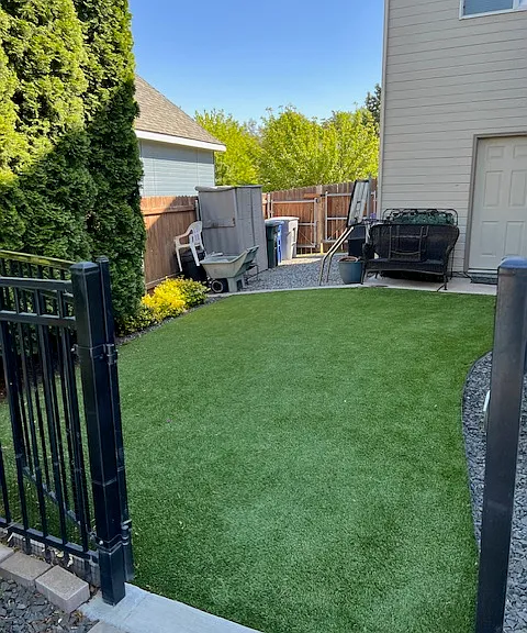 Artificial turf in the back makes lawn care a breeze.