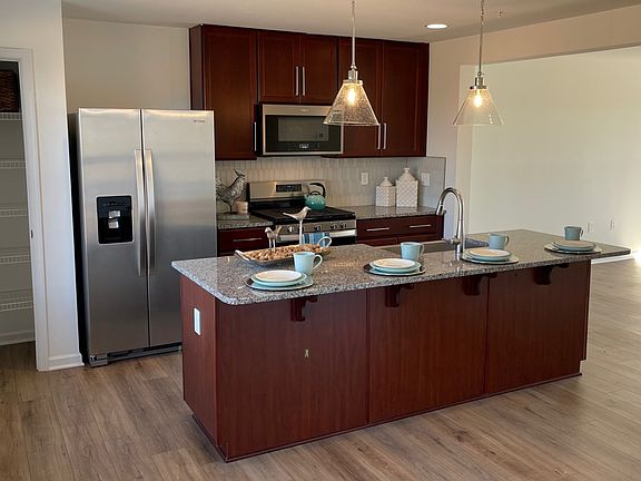 Island kitchen nd adjacent living room in a DRB Homes York II Garage model in the Homestead Acres C