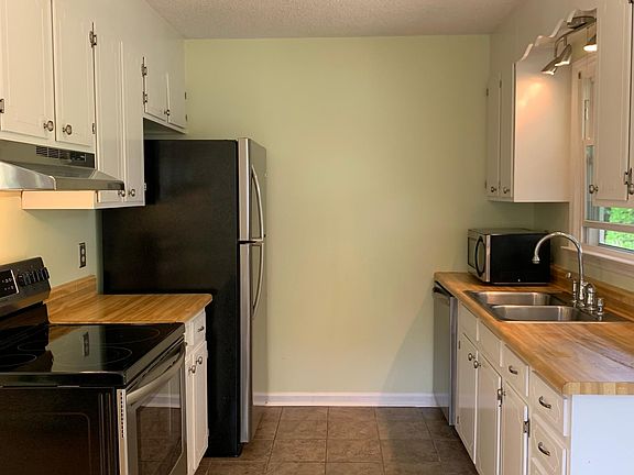 Kitchen with brand new stainless steel appliances.