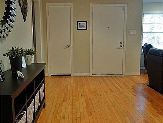 The front door enters into the living room area, providing an expandable entry foyer. Refinished hardwoods cover the living room.