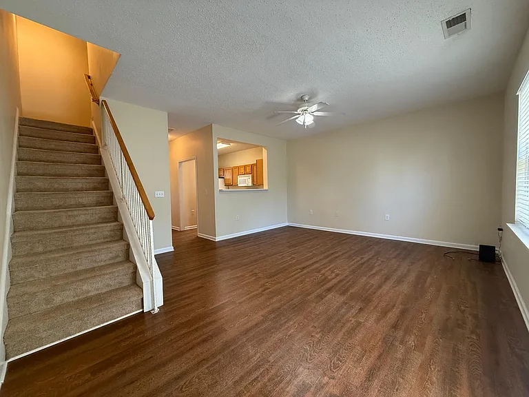 Large living room with luxury vinyl planking. Breakfast bar pass through for more open feeling.