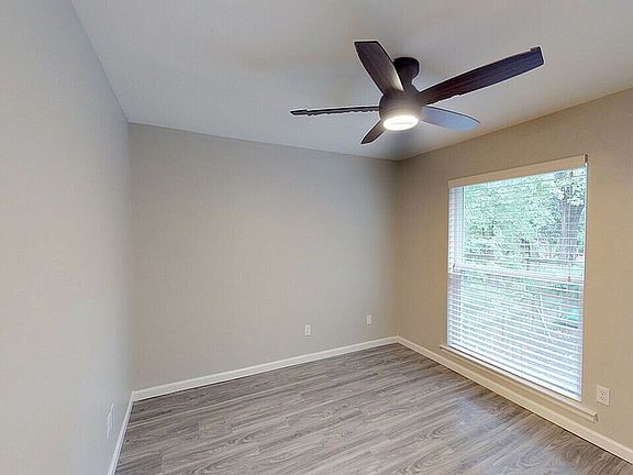 Experience comfort in this bright bedroom, featuring sleek modern finishes.