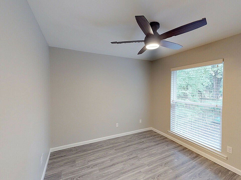 Experience comfort in this bright bedroom, featuring sleek modern finishes.